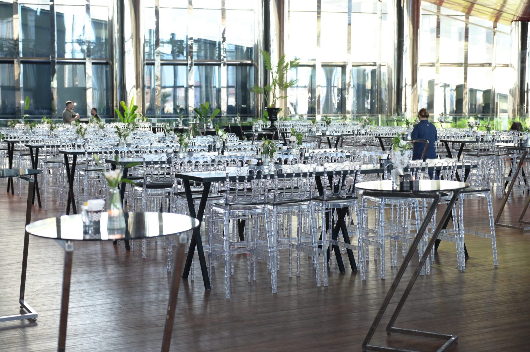 Glass-walled hall set with cocktail tables